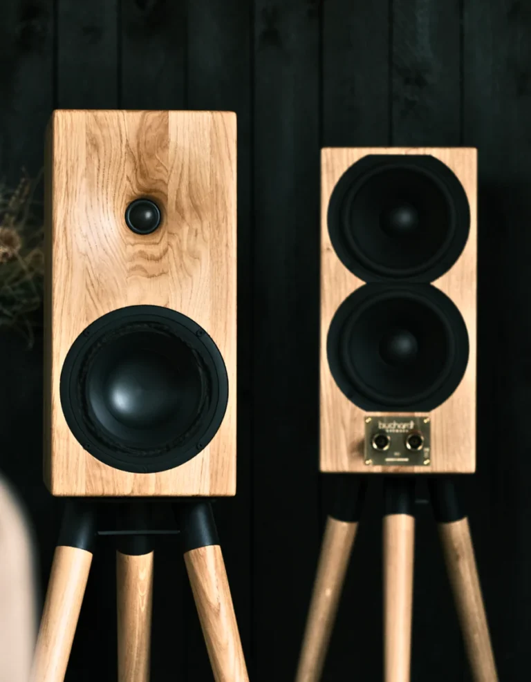 Buchardt E50 Bookshelf Speakers with oak wood finish on a stand