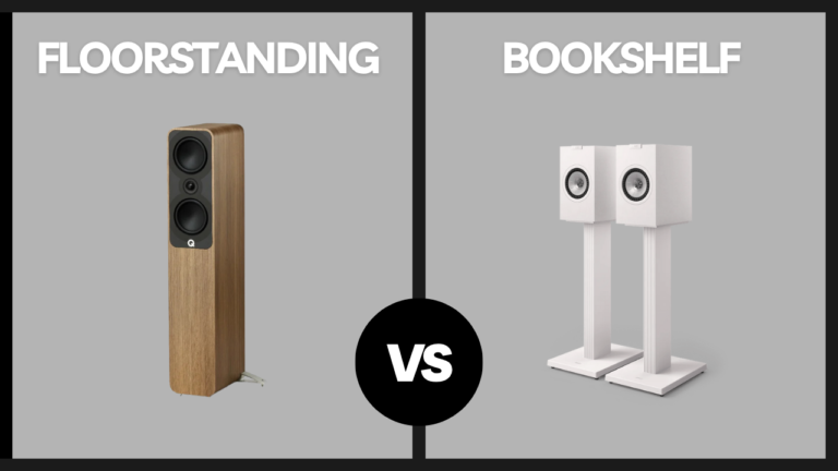 Side-by-side comparison of a single floorstanding speaker and a pair of white bookshelf speakers on stands, with a ‘VS’ symbol in the center on a gray background