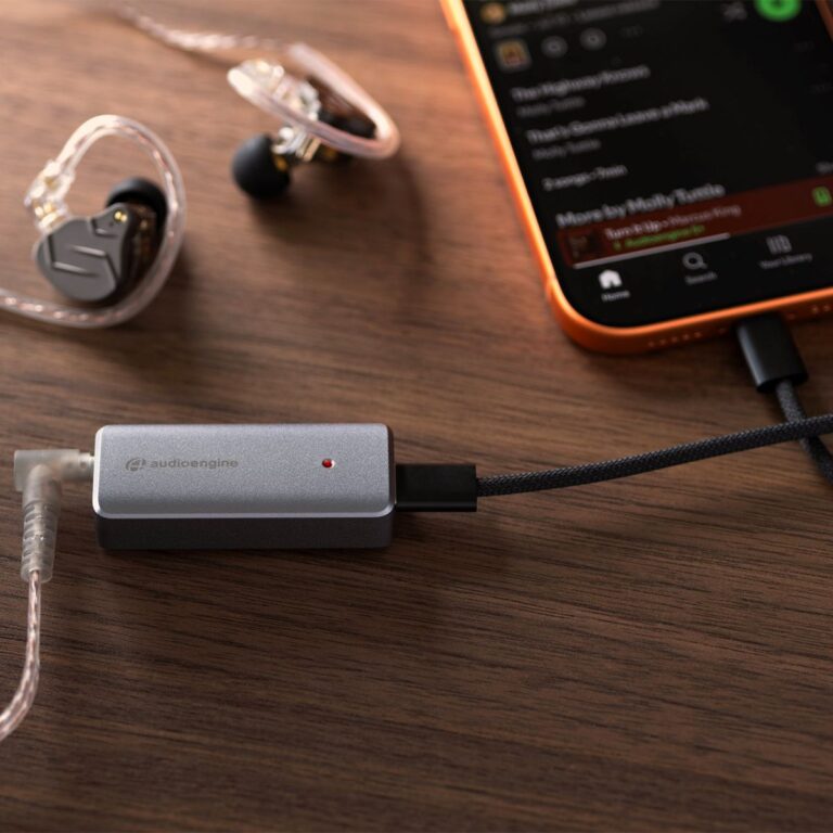 AudioEngine HXL headphone amplifier and DAC connected to a phone and Beats earbuds